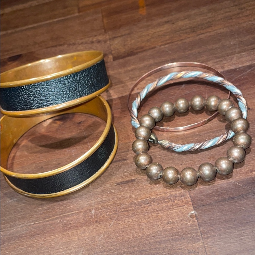 Elegant Black and Gold Bangle Set with assortment of other bracelets